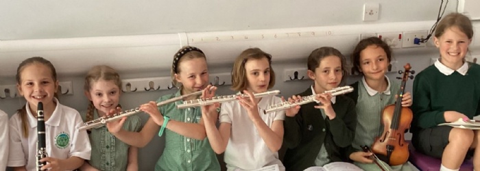 Exwick pupils sat with musical instruments 